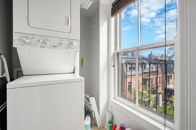 washroom featuring stacked washer and clothes dryer