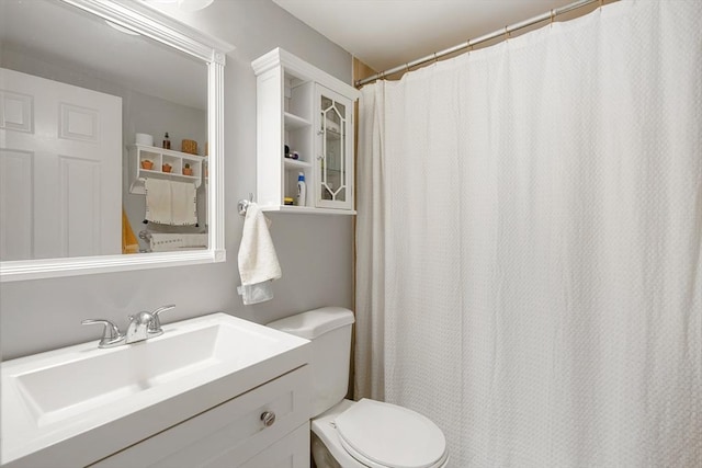 full bathroom with toilet and vanity