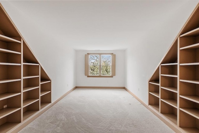 interior space featuring light carpet and baseboards