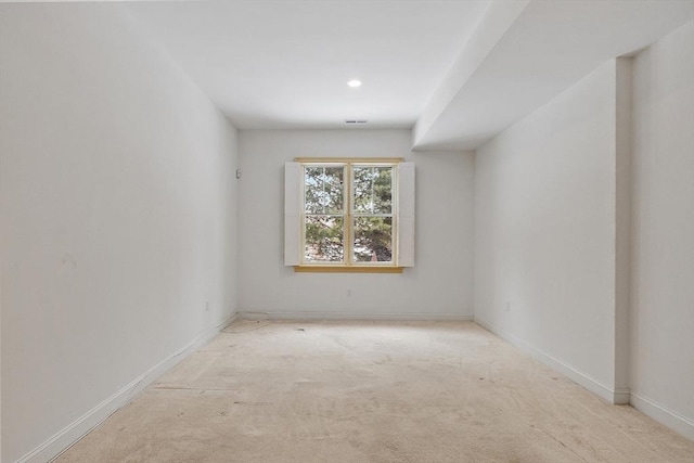 empty room with light carpet, visible vents, and baseboards