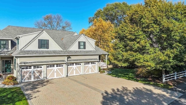 garage with driveway and fence