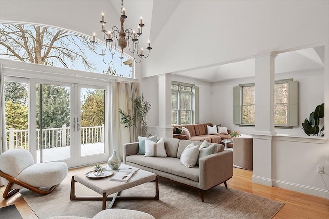 sunroom / solarium featuring french doors and decorative columns