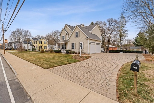 view of front of house with a front yard and a garage