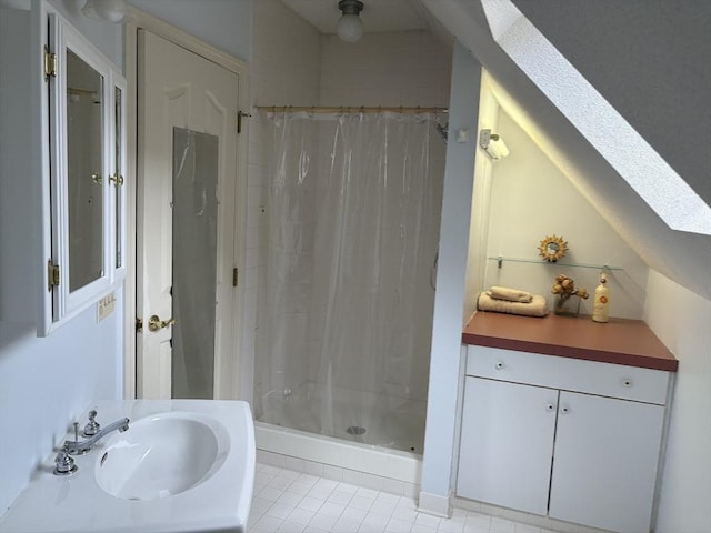 bathroom with sink, curtained shower, and a skylight