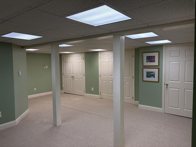 basement with light carpet and a drop ceiling