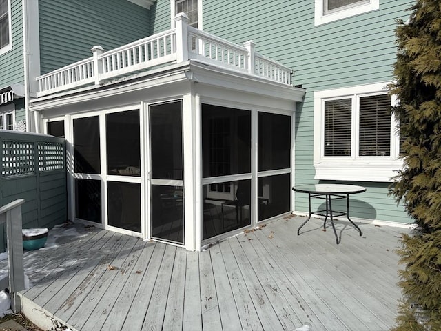 wooden terrace featuring a sunroom