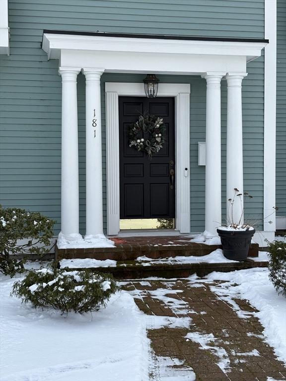 view of snow covered property entrance