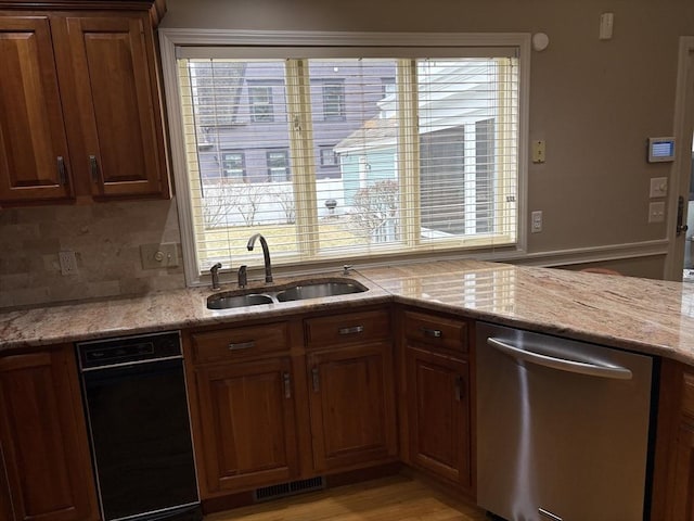 kitchen with sink, backsplash, a wealth of natural light, and dishwasher