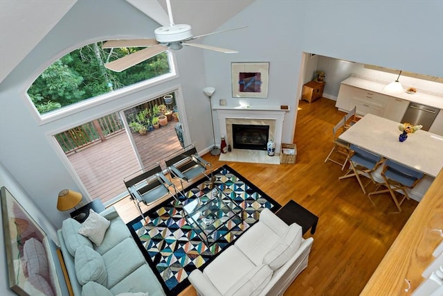 15 Berrywood Ct Unit 15, Bourne, MA 02532 - living area featuring ceiling fan, a fireplace, wood finished floors, high vaulted ceiling, and baseboards