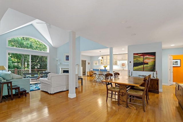 15 Berrywood Ct Unit 15, Bourne, MA 02532 - dining room featuring high vaulted ceiling, light wood finished floors, and a fireplace