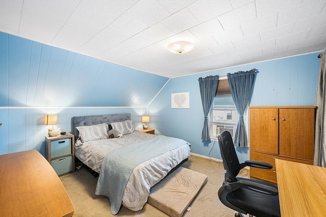 bedroom with light carpet, lofted ceiling, and baseboards