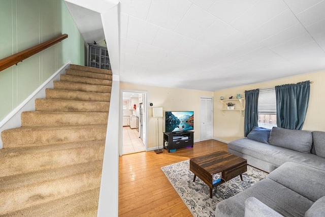 living area featuring hardwood / wood-style floors and stairs