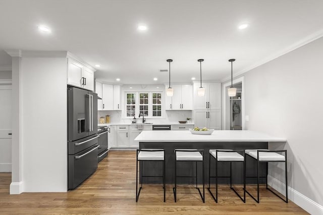 315 Maple Ave, Shrewsbury, MA 01545 - kitchen featuring high quality appliances, a kitchen breakfast bar, white cabinetry, recessed lighting, and light countertops