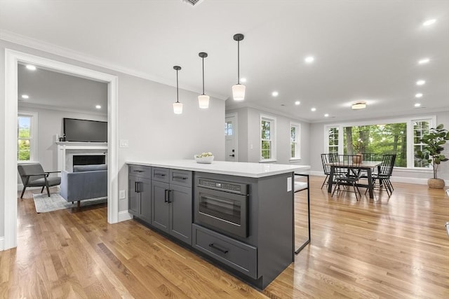 315 Maple Ave, Shrewsbury, MA 01545 - kitchen featuring gray cabinets, crown molding, a kitchen breakfast bar, plenty of natural light, and recessed lighting