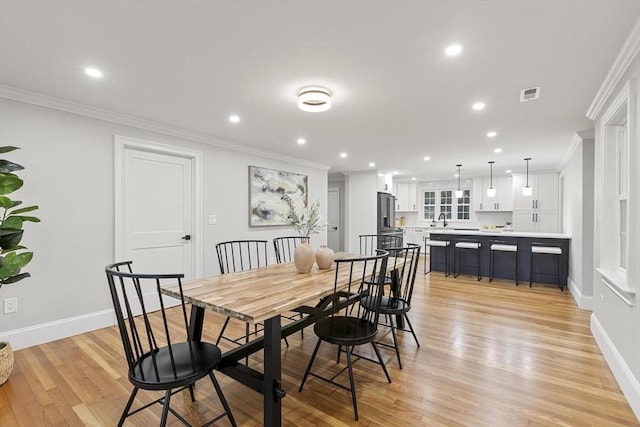 315 Maple Ave, Shrewsbury, MA 01545 - dining area with ornamental molding, light wood-style flooring, baseboards, and recessed lighting