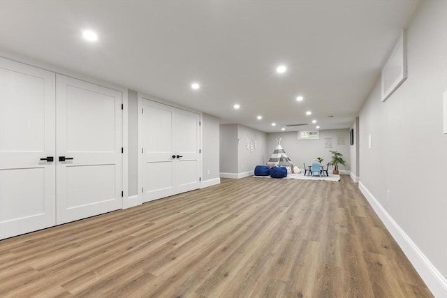 315 Maple Ave, Shrewsbury, MA 01545 - finished below grade area with light wood finished floors, recessed lighting, and baseboards