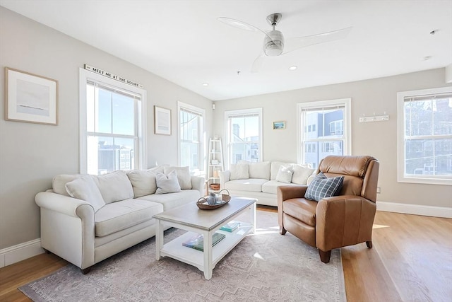 living room featuring light hardwood / wood-style flooring and ceiling fan