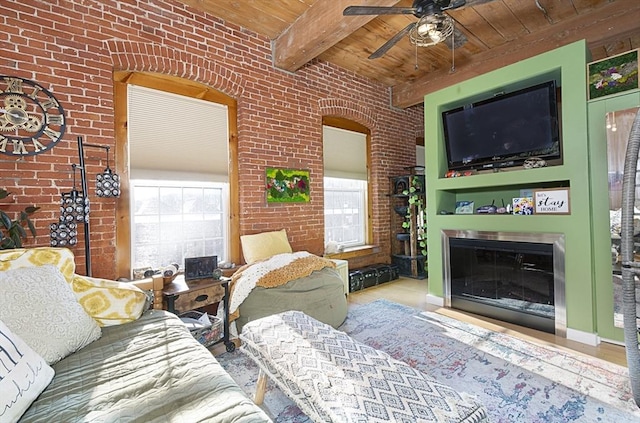 living room with brick wall, a healthy amount of sunlight, wooden ceiling, and beam ceiling