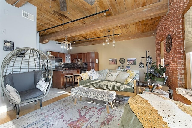 living room with beamed ceiling, track lighting, wood ceiling, and light wood-type flooring