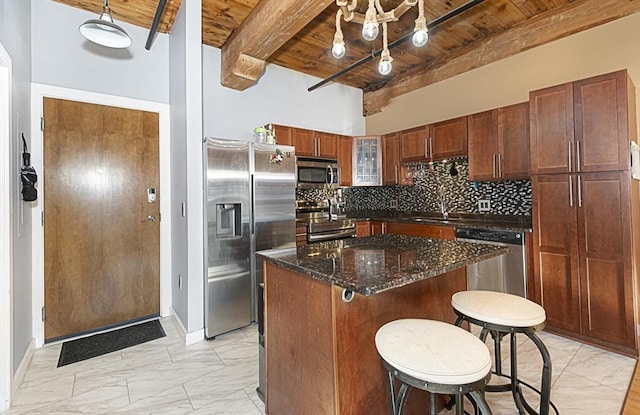 kitchen featuring a breakfast bar, a center island, wooden ceiling, appliances with stainless steel finishes, and beam ceiling