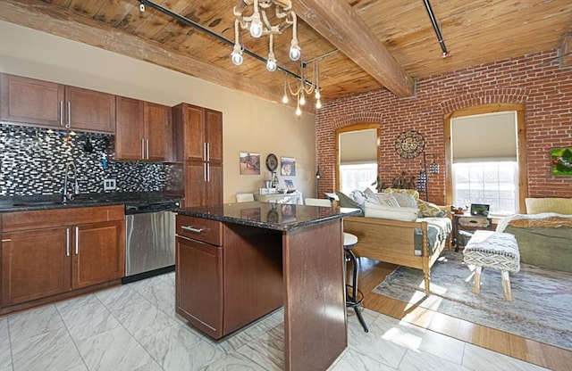 kitchen featuring wood ceiling, a center island, stainless steel dishwasher, beamed ceiling, and brick wall