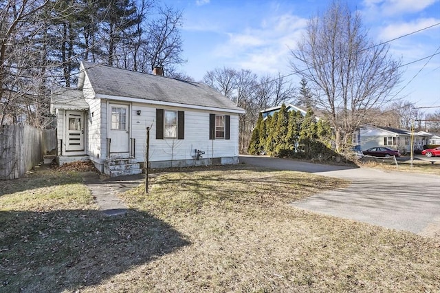 bungalow-style home with a front yard