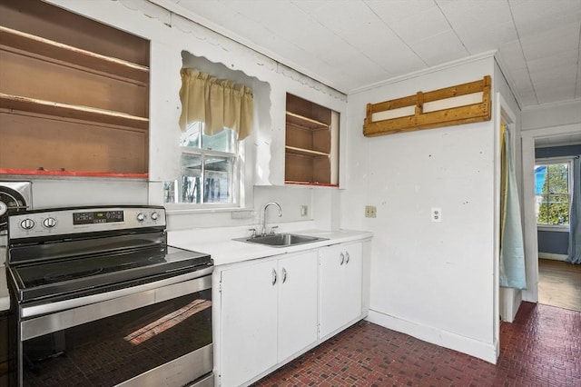 kitchen featuring sink, stainless steel electric range oven, white cabinetry, and ornamental molding