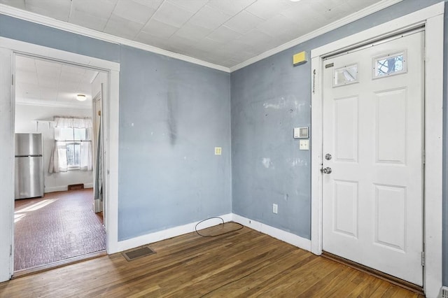 entryway with crown molding and hardwood / wood-style flooring