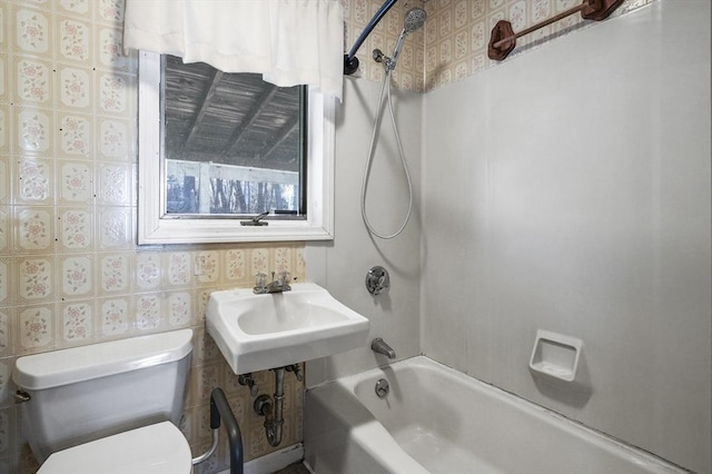 full bathroom featuring sink, shower / bath combination, and toilet