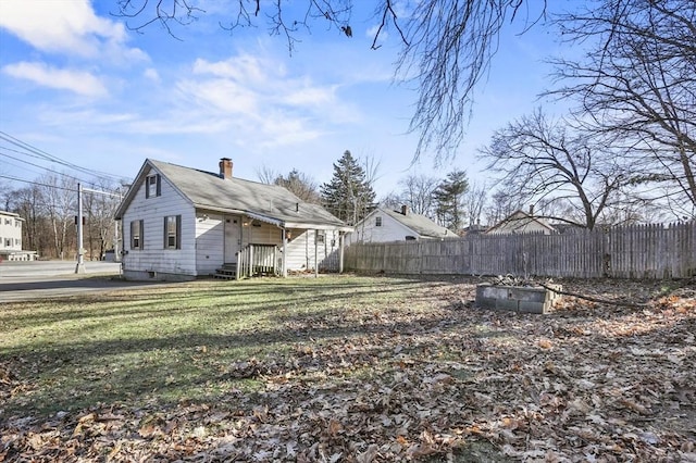 rear view of property with a lawn