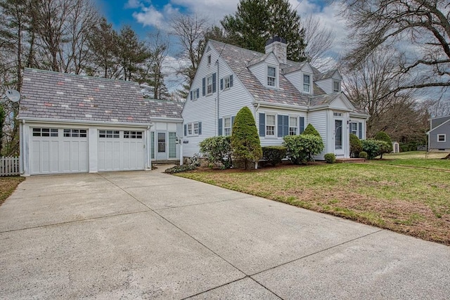 27 Carrlyn Rd, Brockton, MA 02301 - view of property exterior featuring a yard, entry steps, a garage, a chimney, and driveway