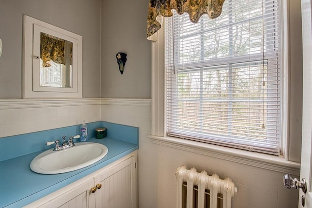 27 Carrlyn Rd, Brockton, MA 02301 - bathroom with radiator heating unit, vanity, and a healthy amount of sunlight