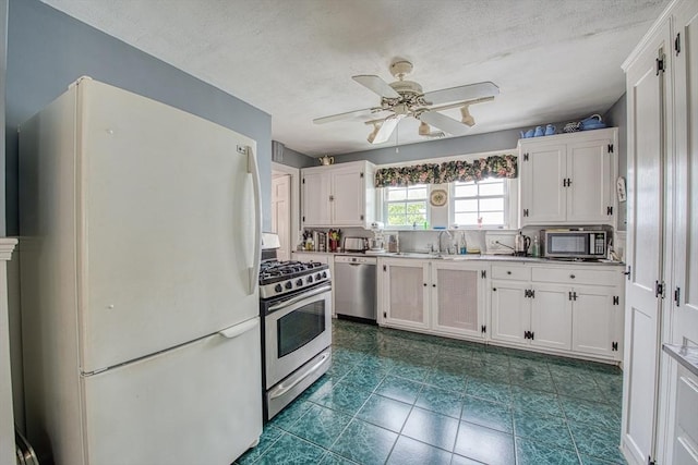 27 Carrlyn Rd, Brockton, MA 02301 - kitchen featuring light countertops, appliances with stainless steel finishes, a ceiling fan, a textured ceiling, and white cabinetry
