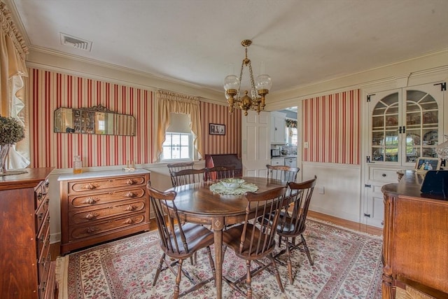 27 Carrlyn Rd, Brockton, MA 02301 - dining area featuring ornamental molding, visible vents, light wood-style flooring, and a notable chandelier