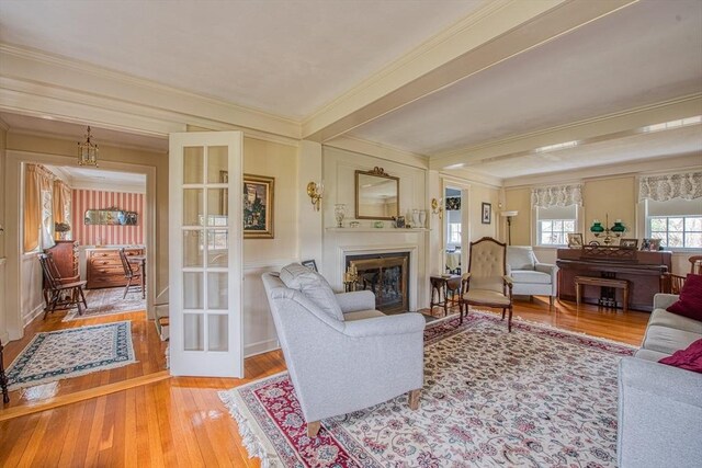 27 Carrlyn Rd, Brockton, MA 02301 - living room featuring a glass covered fireplace, beamed ceiling, wood-type flooring, and crown molding