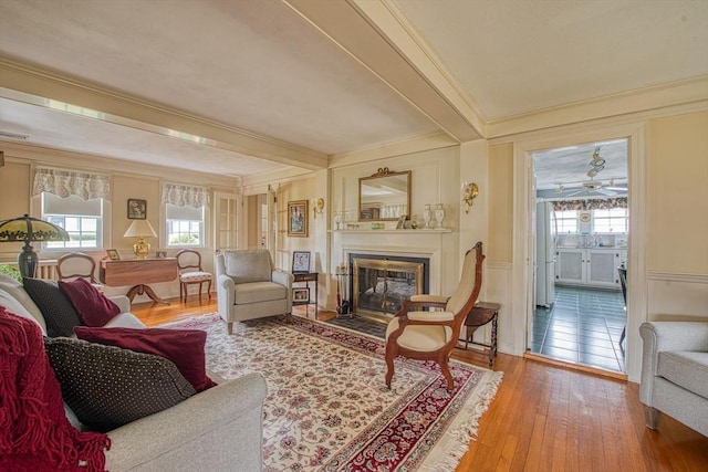 27 Carrlyn Rd, Brockton, MA 02301 - living room with crown molding, beam ceiling, hardwood / wood-style floors, and a fireplace with flush hearth