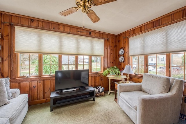27 Carrlyn Rd, Brockton, MA 02301 - living area with wood walls, light colored carpet, and a ceiling fan