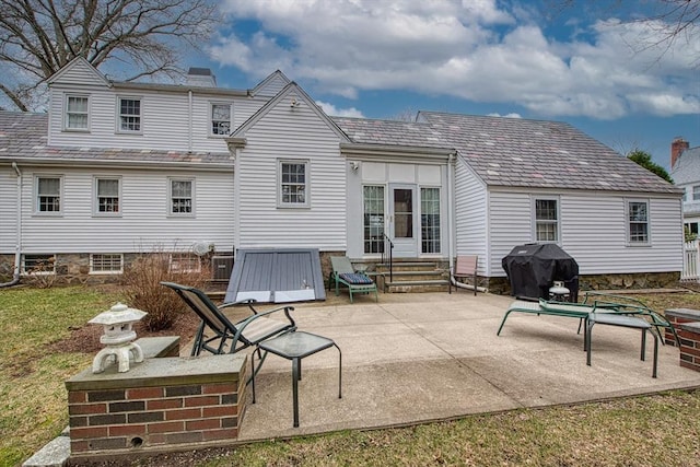 27 Carrlyn Rd, Brockton, MA 02301 - back of property with a patio, entry steps, and a chimney
