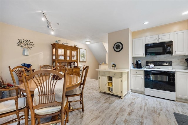 63 Shrine Ave Unit 1, West Boylston, MA 01583 - kitchen featuring white range with electric stovetop, black microwave, light countertops, backsplash, and light wood-style flooring