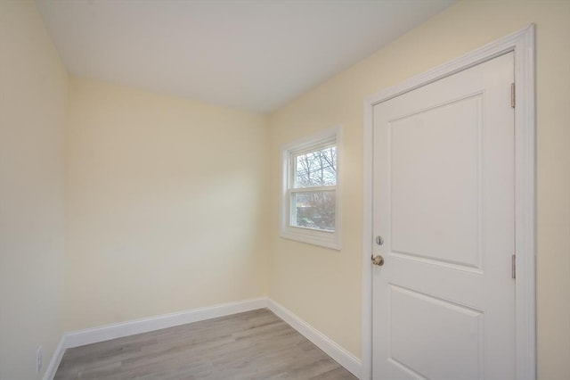 doorway to outside featuring light wood finished floors and baseboards