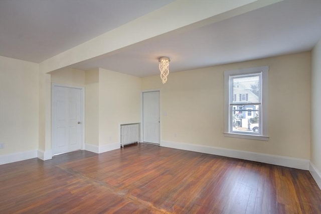 empty room with wood finished floors and baseboards