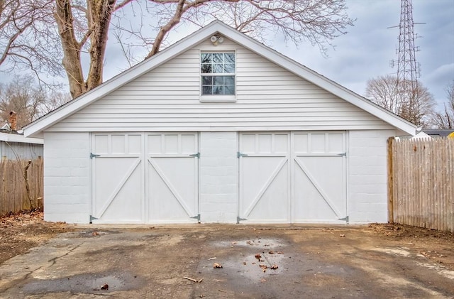 detached garage featuring fence
