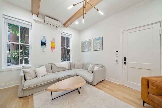 living room with beam ceiling, a wall mounted AC, and light wood-type flooring