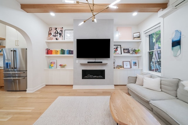 living room with beamed ceiling and light hardwood / wood-style flooring