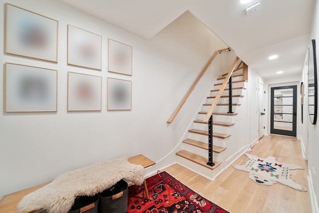 stairway featuring hardwood / wood-style floors