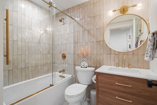 full bathroom featuring decorative backsplash, toilet, tile walls, vanity, and shower / bath combination with glass door