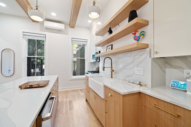 kitchen with beam ceiling, tasteful backsplash, light wood-type flooring, a wall mounted air conditioner, and light stone counters