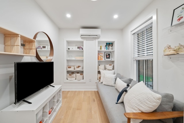 interior space featuring a wall mounted AC and light wood-type flooring