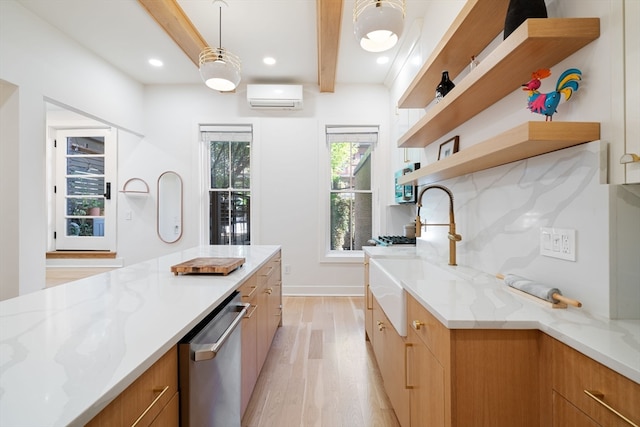 kitchen featuring a wall mounted AC, beam ceiling, decorative light fixtures, stainless steel dishwasher, and light hardwood / wood-style floors