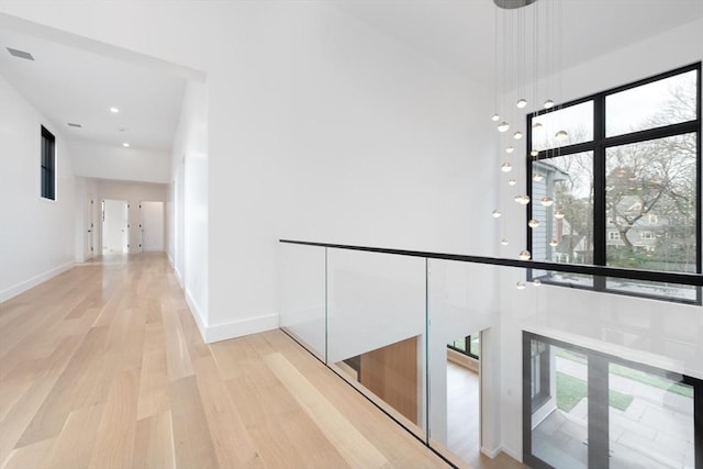 corridor with light hardwood / wood-style flooring